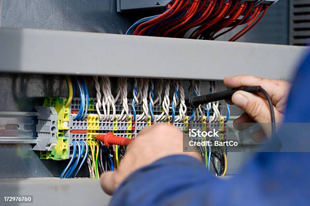 Electrician At Work With His Instrument Of Measurement Stock Photo - Download Image Now