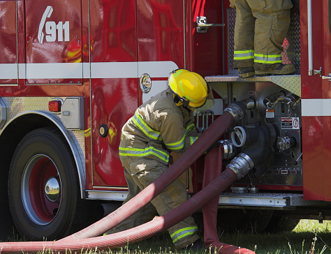 Red helmet in fireman's hand