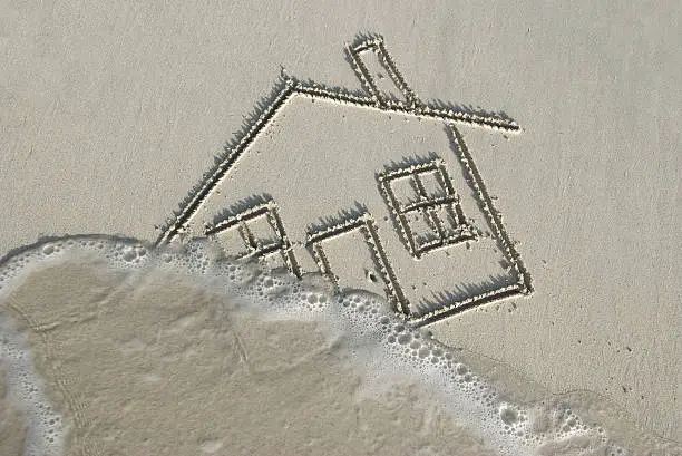 Photo of Drawing of a Home in Sand Swept Away by Wave
