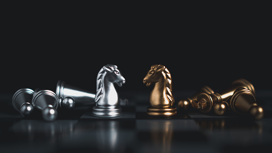 Gold and silver chess pieces in chess board game for business comparison. Leadership concepts, human resource management concepts, business administration concepts.