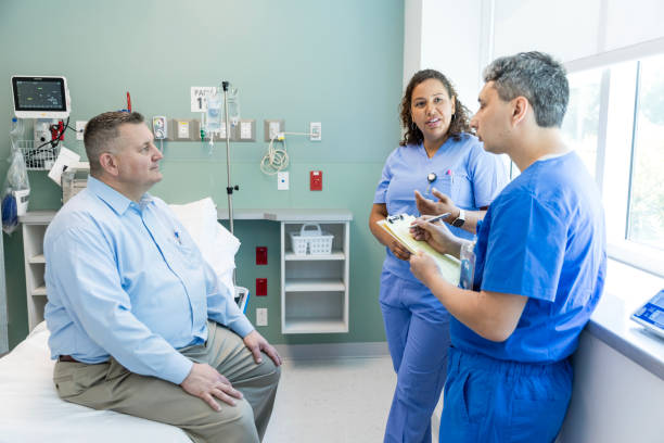 istock Diverse medical team asks male patient questions about symptoms 1729780235