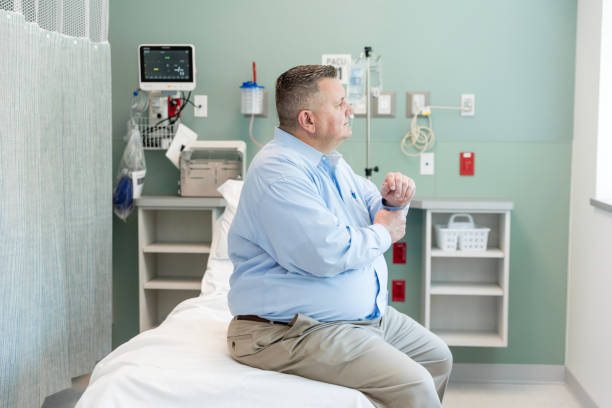 istock Profile view man sitting in ER examination room 1729780254
