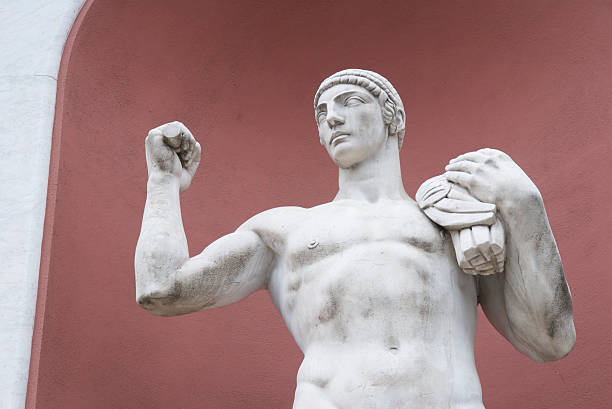 istock Statue of Muscular Athlete Against Red 172978153