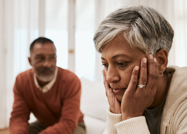 istock Divorce, crisis and senior couple on sofa with problem, fail or angry, argument or dispute at home. Marriage, stress and annoyed man with woman in living room for depression, abuse or cheating guilt 1729784541