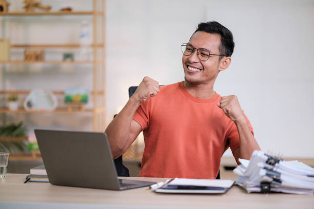 istock Young man success celebration at office 1729786874