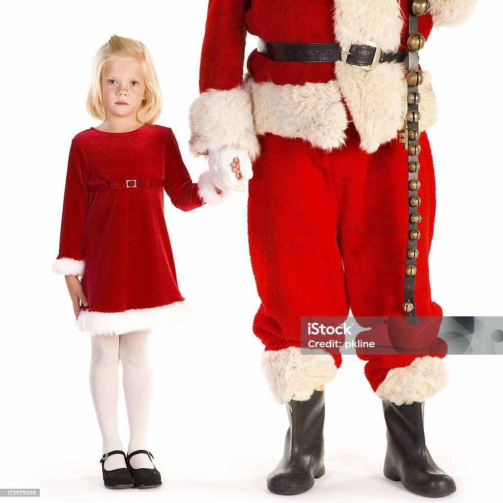 Little girl holding Santa's mano mira a la cámara - Foto de stock de 4-5 años libre de derechos