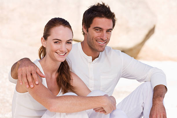 istock Smiling young couple sitting together 172979581