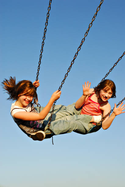 istock Twin Sisters Swining in Tandem 172979722