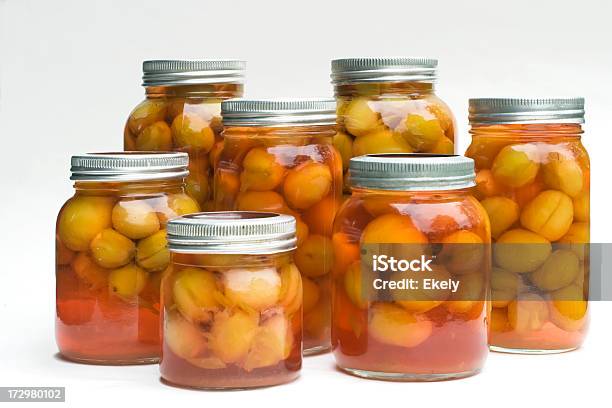 Standing Preserved Plums On Glass Jars With Metal Lids Stock Photo - Download Image Now