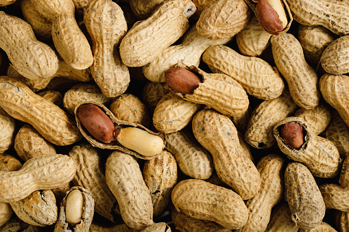 Background of a large group of Peanuts. Top view of heap of peanuts, full frame.
