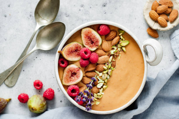 istock Healthy breakfast of smoothie bowl on white table 1729805264