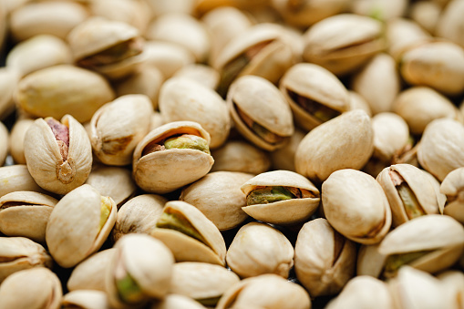 Full frame of pistachio with shells. Close-up of healthy dry fruits.