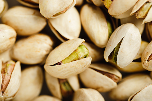 Top view of roasted pistachios. Full frame of pistachio with shells background.