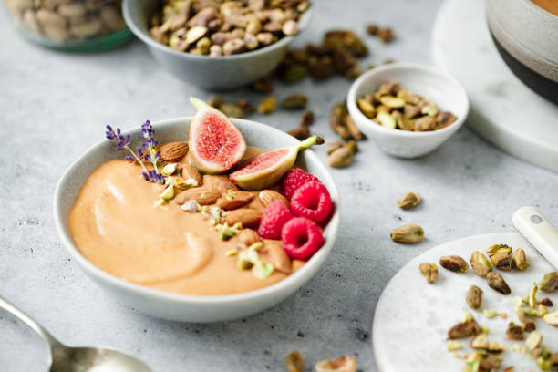 istock Freshly made smoothie garnished with dry fruits on kitchen 1729805276