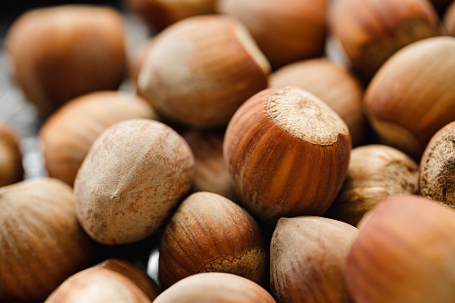 Close-up of hazelnuts. Full frame of whole hazelnuts on table.