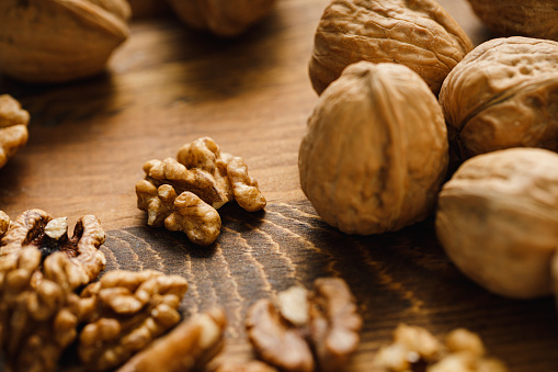 Close-up of whole and peeled walnuts. Natural walnuts on table.