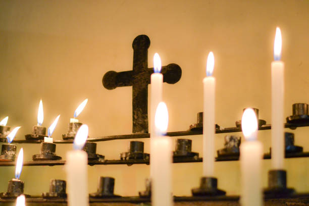istock Candles in a Sanctuary with a Cross in the Background 1729826701