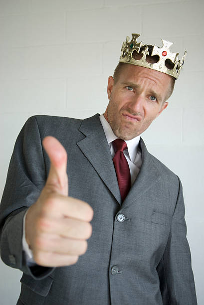 istock Arrogant Businessman with Crown Gives Thumbs Up 172983083