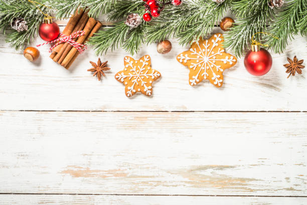 istock Christmas spices with gingerbread cookies at white table with holidays decorations. 1729833733