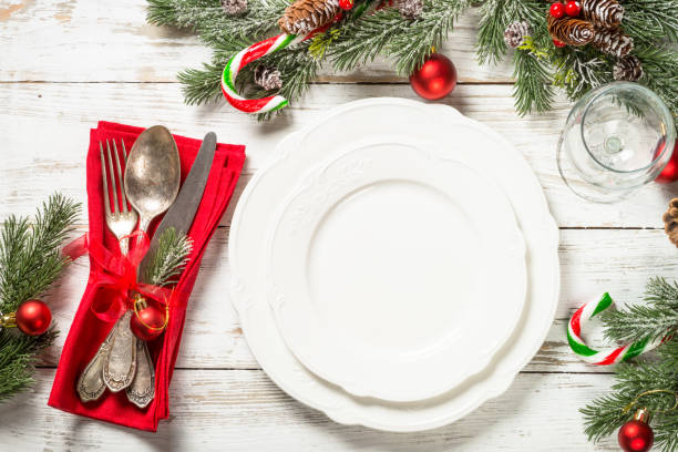 istock Christmas table setting with holidays decorations at white wooden table. 1729834796