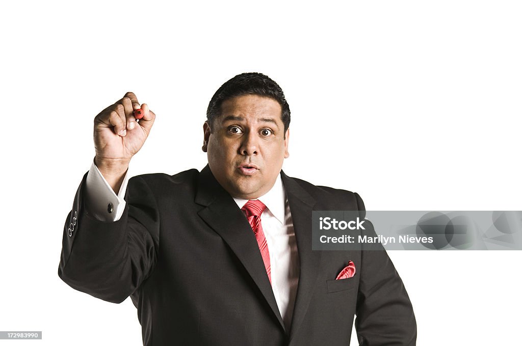 expressive businessman writing on the wall Hispanic businessman writing on wall. Adult Stock Photo