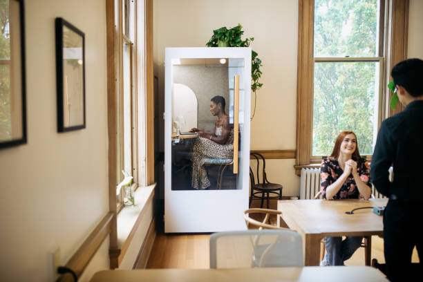 Woman Working In Soundproof Booth In Office