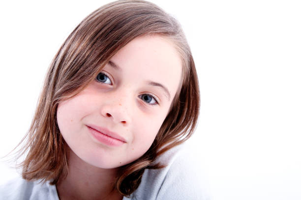 Young beautiful child girl wearing casual t-shirt standing over isolated white background with a confident expression on smart face thinking serious