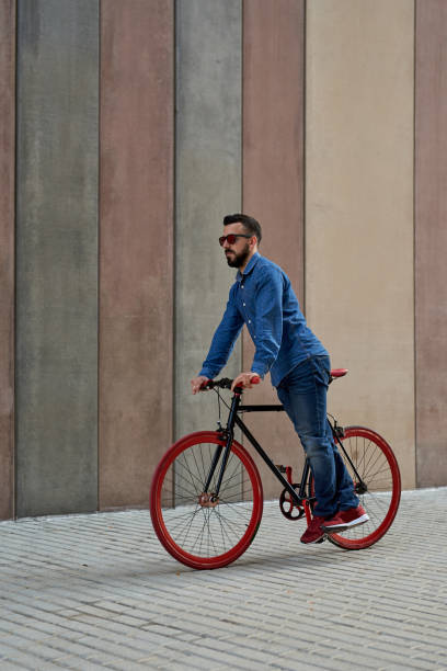istock Young man riding a bicycle outdoors 1729846783
