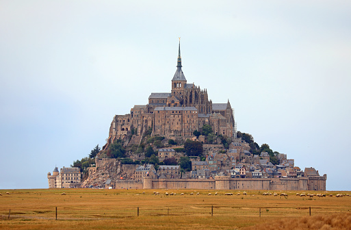 Mont Saint Michel with the Abbey church built above the hill during low tide in northern France