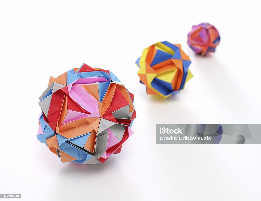 Three multicolored geometric origami polyhedron paper craft  Origami Stock Photo