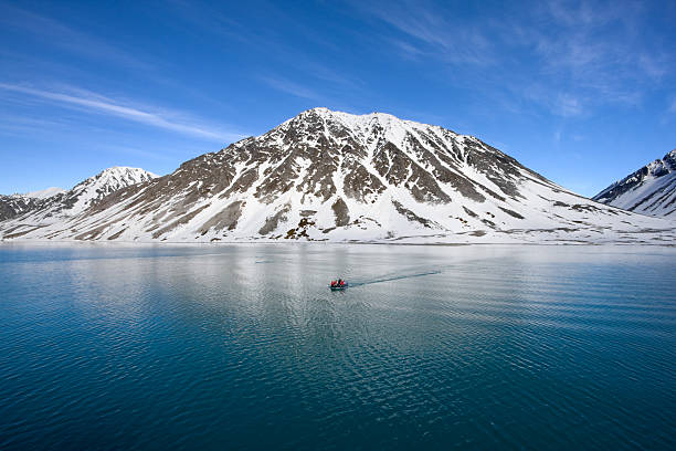 Boat by cold mountain stock photo