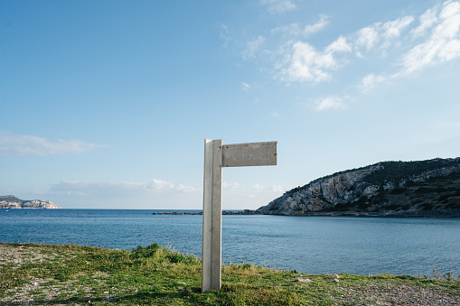 White signpost without inscription on the background of a sea bay