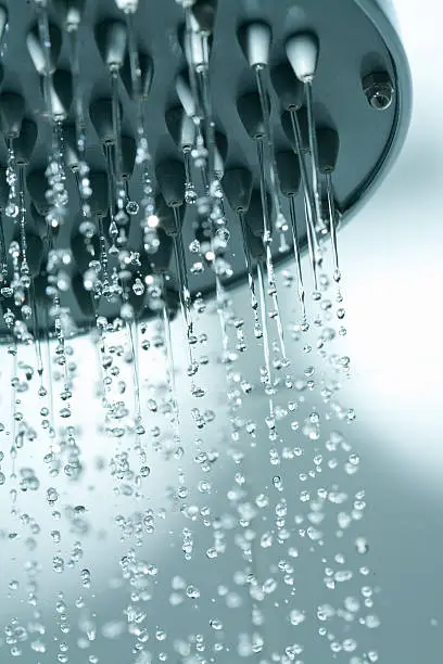 Closeup showerhead with frozen water droplets.