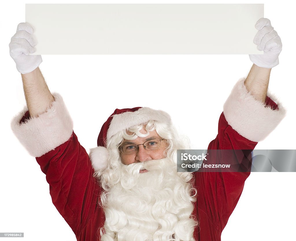 Santa Holding a Banner Overhead Santa Claus holding a blank banner sign up over his head while looking at the camera.   Isolated on white. Above Stock Photo