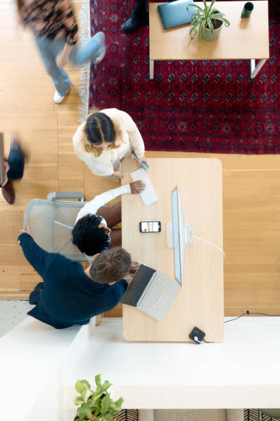 istock High Overhead View of Teamwork in Modern Office Space 1729863628