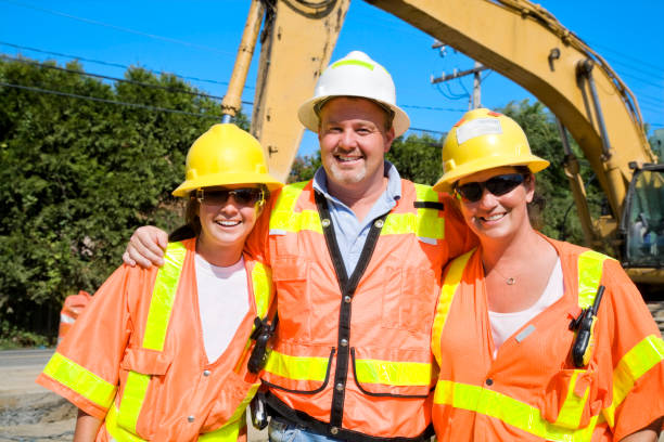 istock Happy Construction workers wearing safety gear orange yellow 172986599
