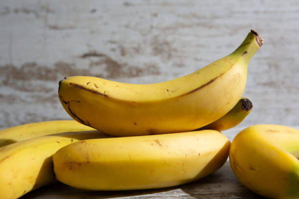 istock A bunch of bananas, placed on wooden table. 1729868454