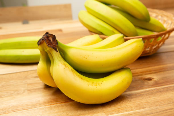 istock A bunch of bananas, placed on wooden table. 1729874301