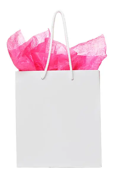 Photo of White colored gift back, with pink paper sticking out 