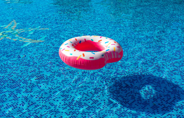 istock Pink inflatable donut swimming ring in a swimming pool 1729881449