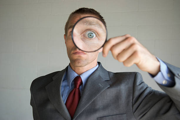 istock Big Eye Magnifying Glass Businessman Invading Privacy 172988332