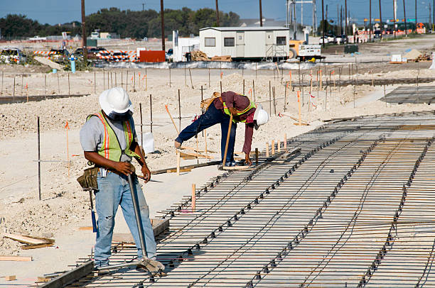 Faceless Men Prepare a Parking Lot stock photo