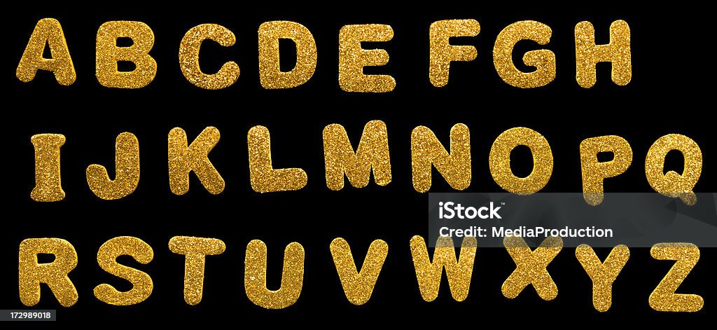Golden letters (Clipping path) XXL Letters punched out of thin foam and dipped in glitter. Alphabet Stock Photo