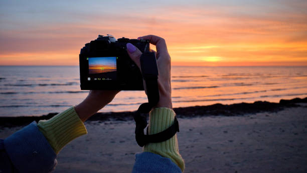 istock Photographing a beautiful sunset with a camera. 1729890235