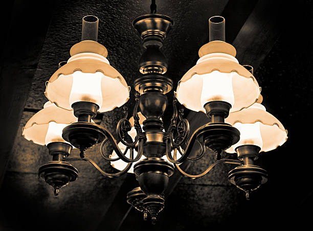 Mysterious looking lit lamp in dark surrounding stock photo