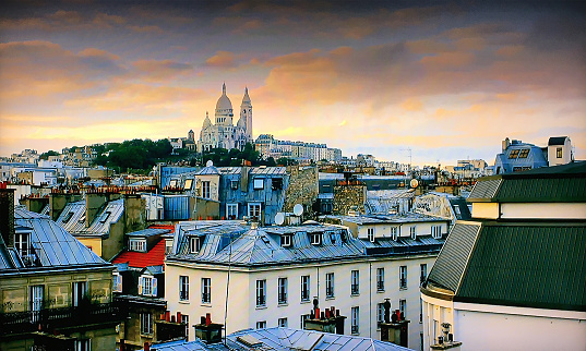 Montmartre hill with Basilique du Sacre-Coeur in Paris at sunset