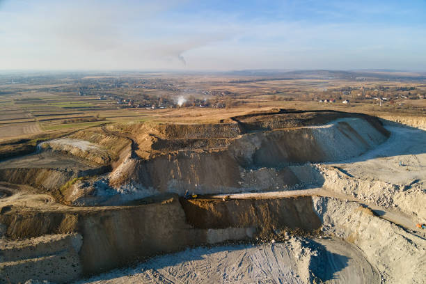 istock Aerial view of open pit mining site of limestone materials for construction industry with excavators and dump trucks 1729897565