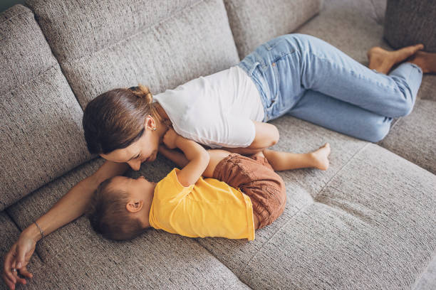 istock Mother and son relaxing on sofa 1729897591