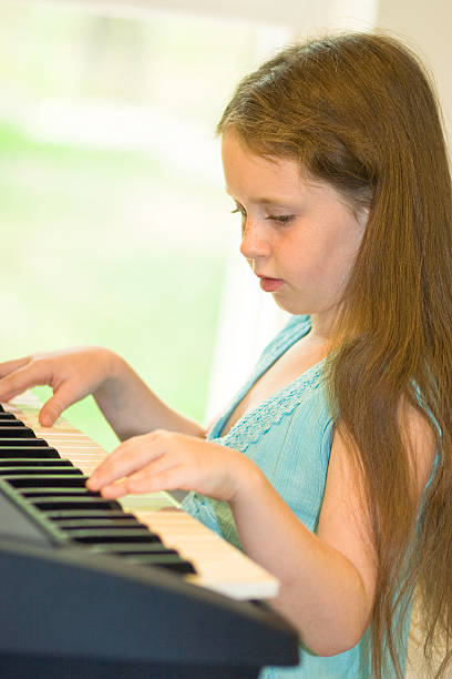 istock Little girl play piano 172989801