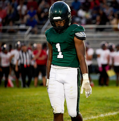 High school star football player displays a small victory walkaway moment